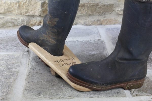 Personalised Wooden Oak Boot Jack in use