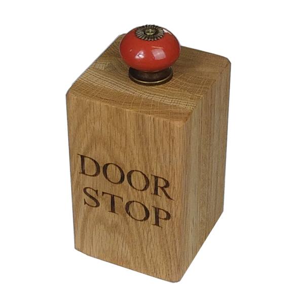 large solid oak doorstop with red door knob