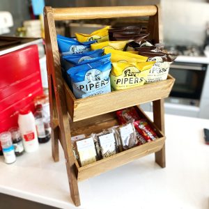 Rustic Brown 2-Tier Adjustable Wooden A-Frame Display Stand 415x300x640 with Slanted Tiers with crisps in cafe